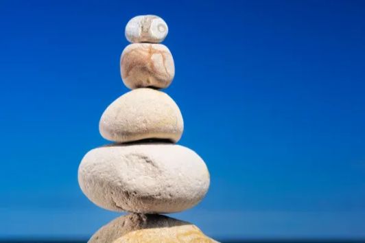 Balanced stones at sunset